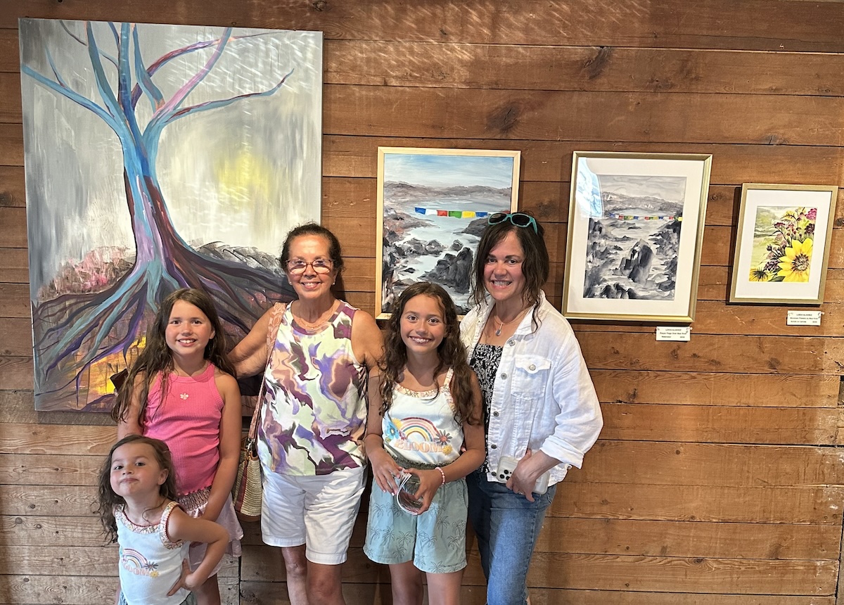 Family of all ages visiting art show at the Big Red Barn, Waitsfield Vermont 2024